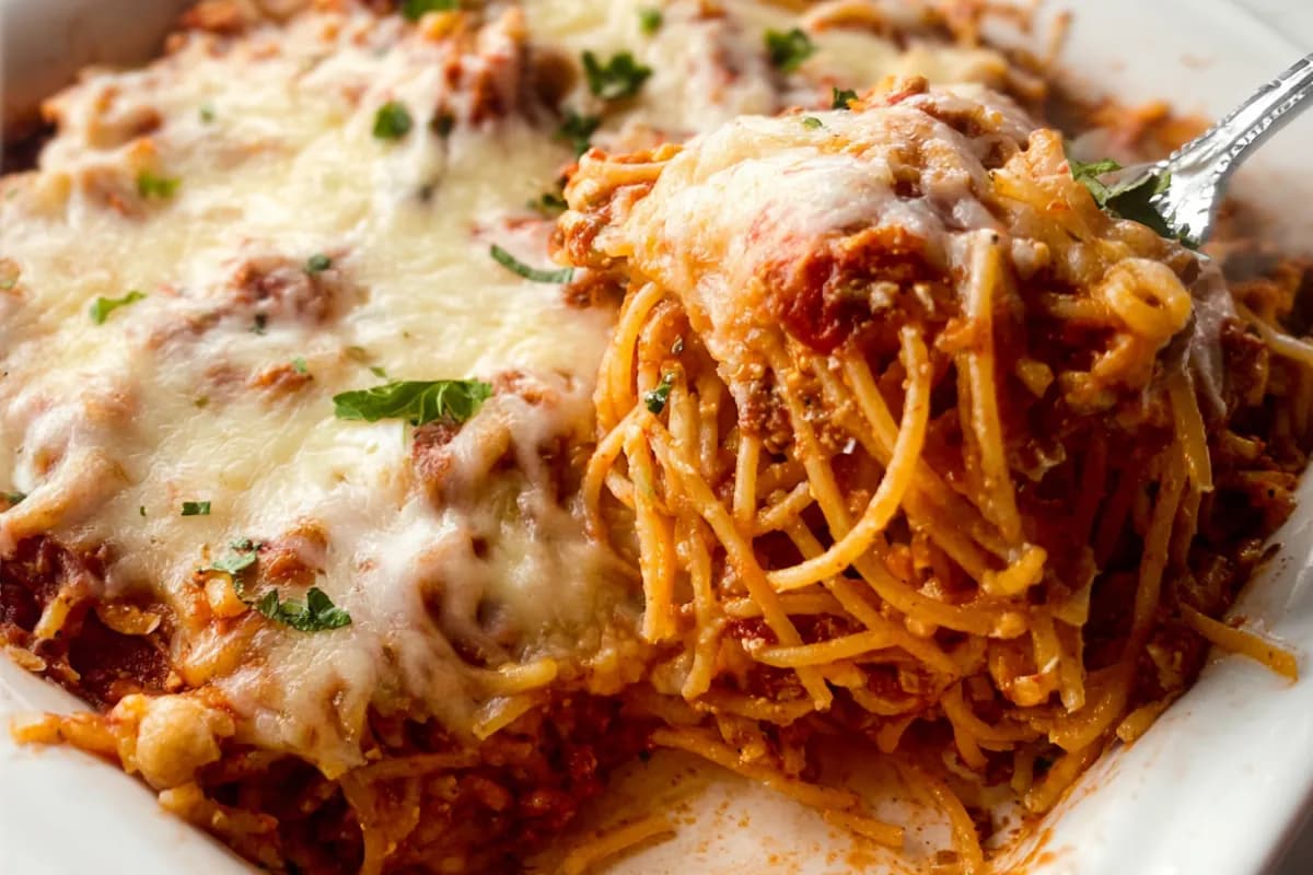 baked cream cheese spaghetti casserole with melted cheese topping