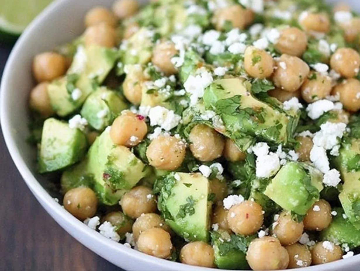 Bowl of Chickpea Feta Avocado Salad with cilantro and lime
