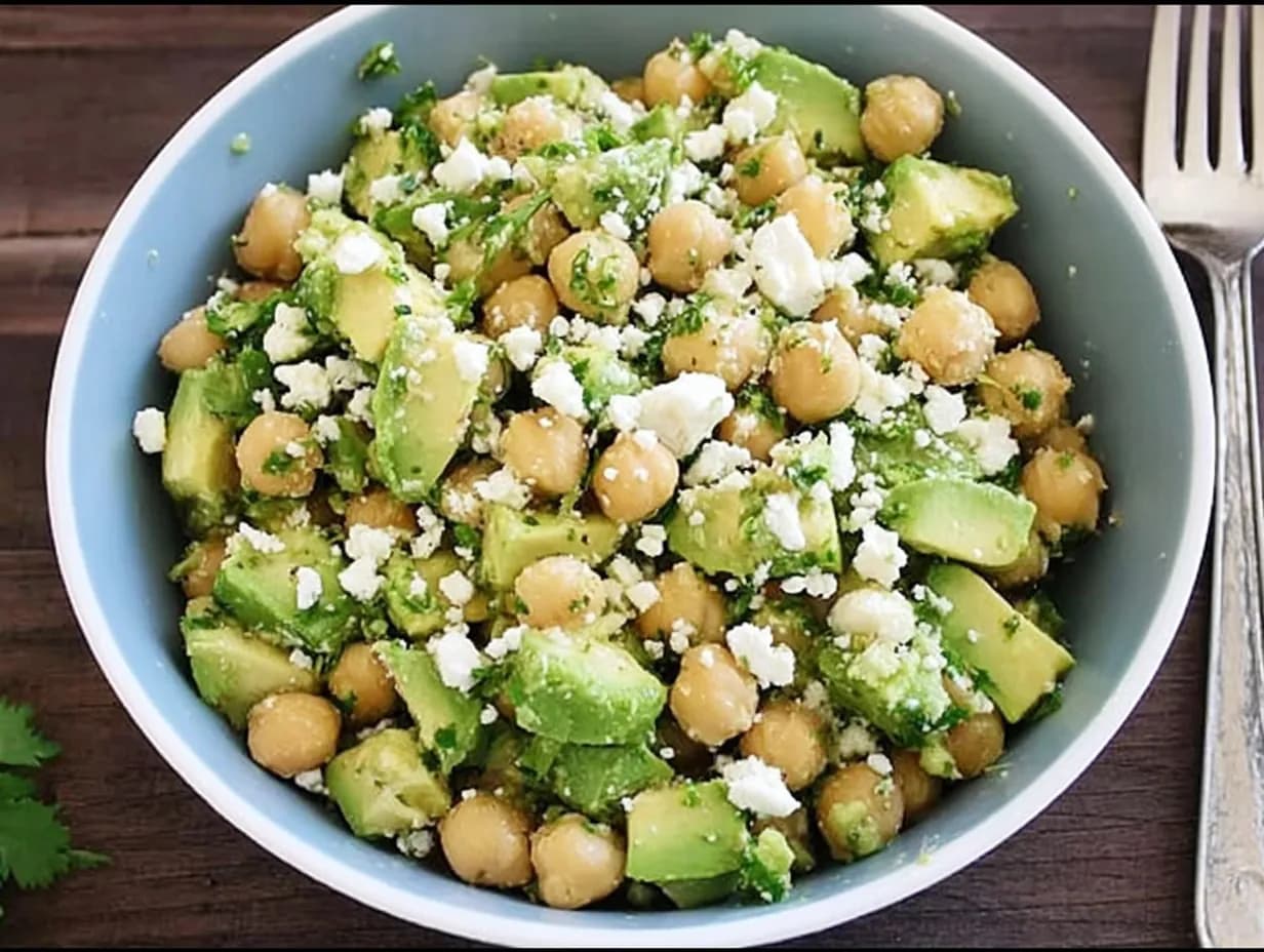 Bowl of Chickpea Feta Avocado Salad served with avocado, chickpeas, cilantro, and feta