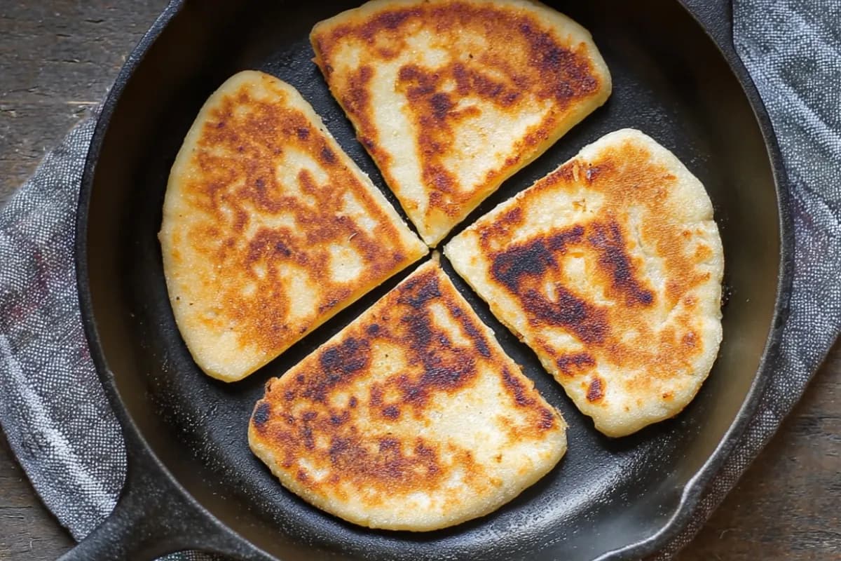 Golden Irish Potato Farls in a cast-iron skillet, freshly cooked