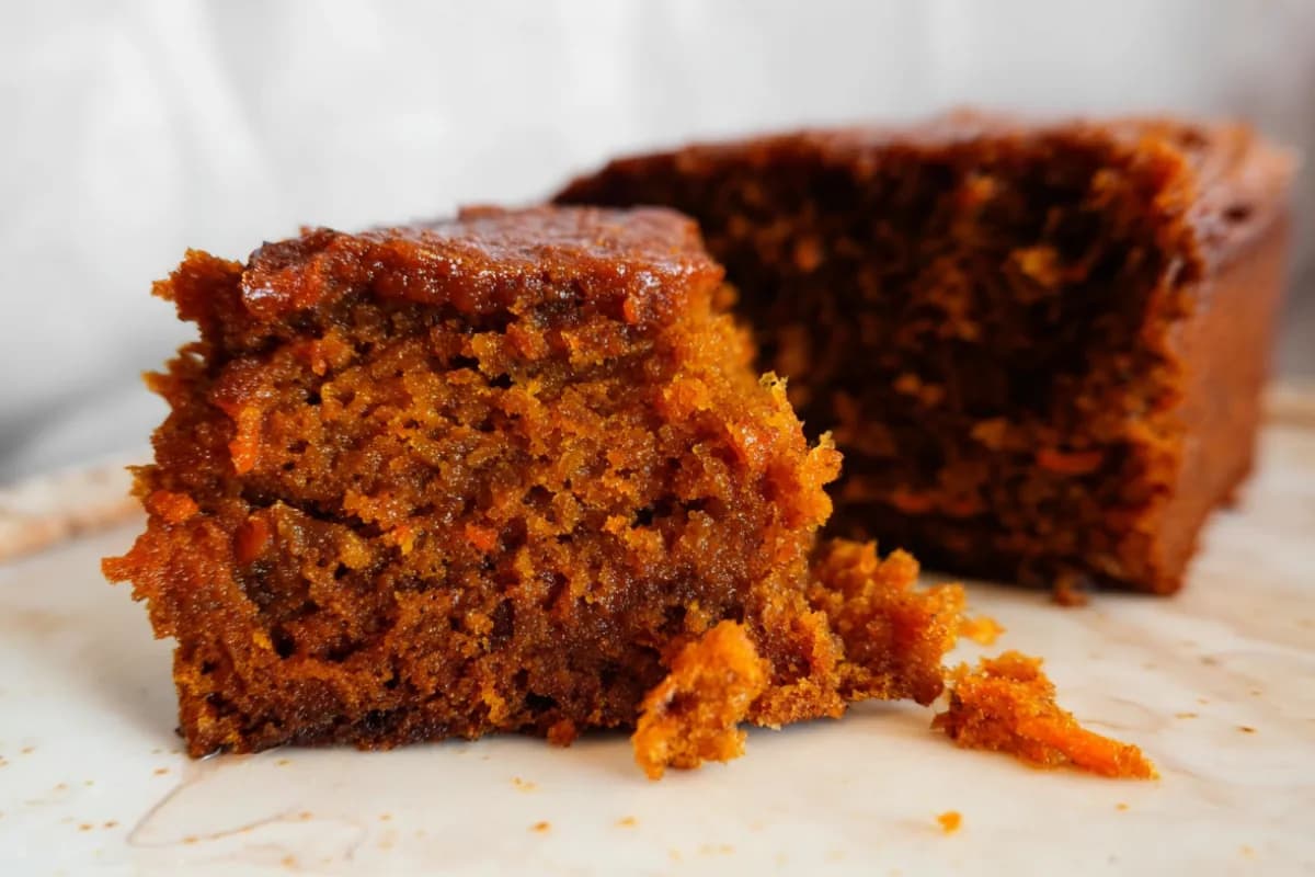 Moist oatmeal carrot cake sliced open with rich golden crumb