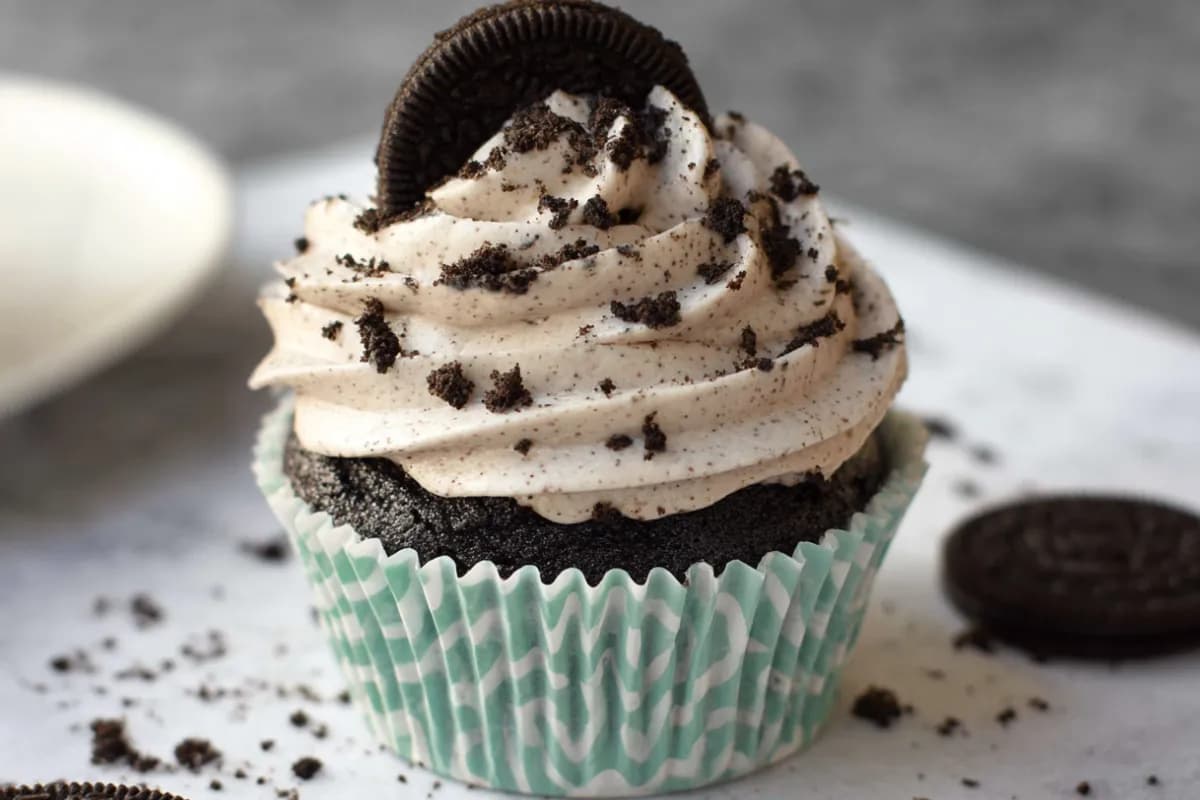 Oreo cream cheese frosting on chocolate cupcake with cookie crumbles