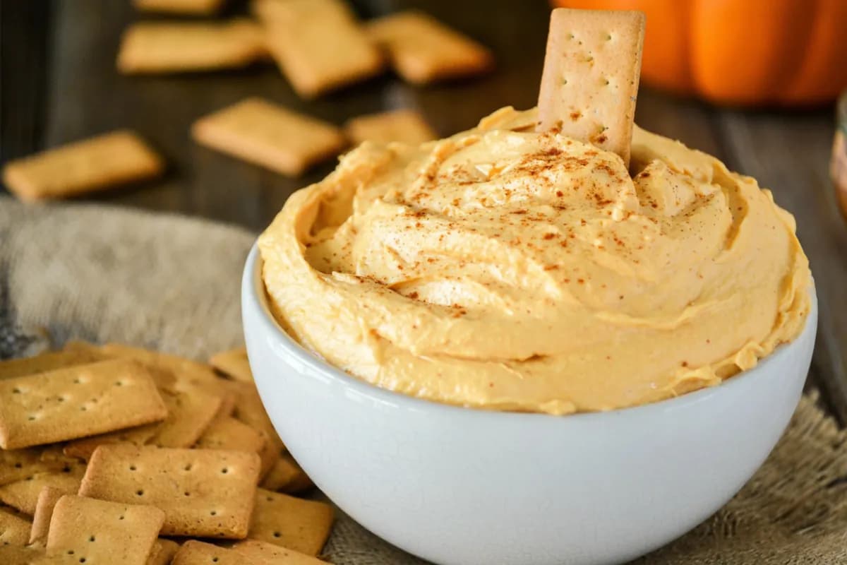pumpkin fluff dip served in white bowl with graham crackers