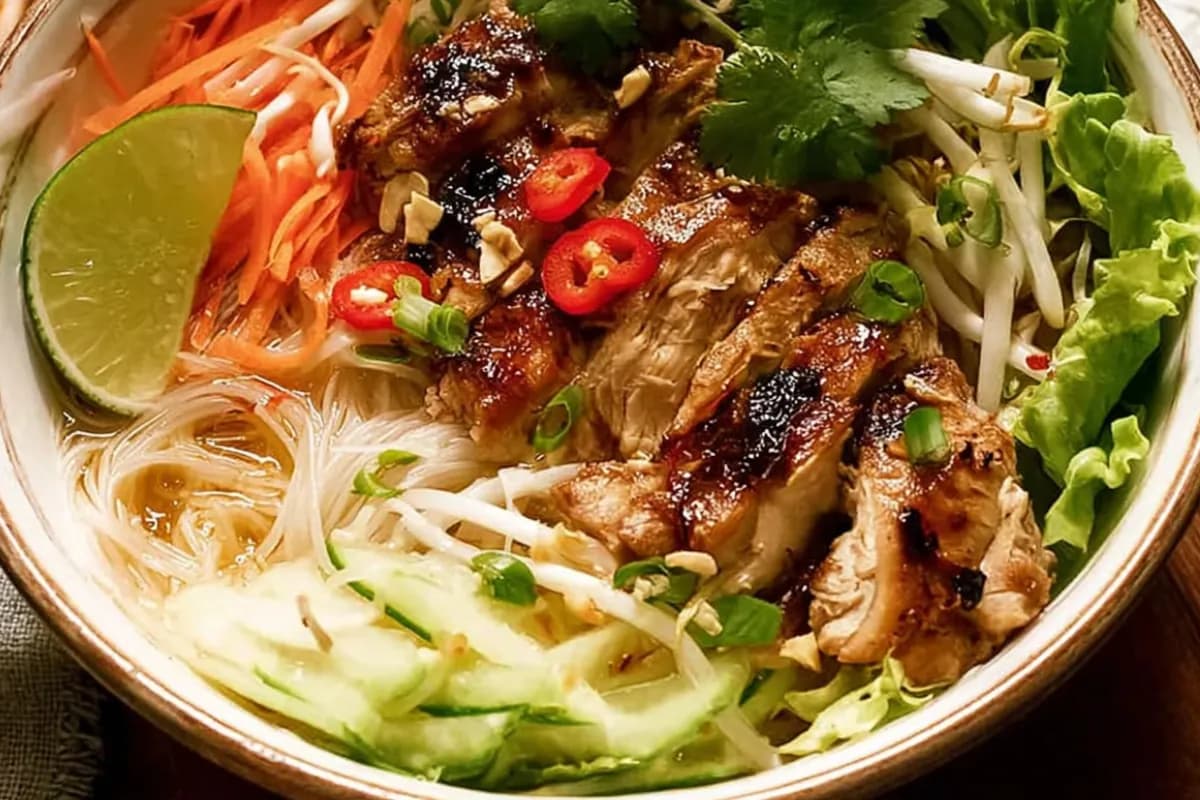 Vietnamese chicken noodle bowl with lemongrass grilled chicken and fresh herbs