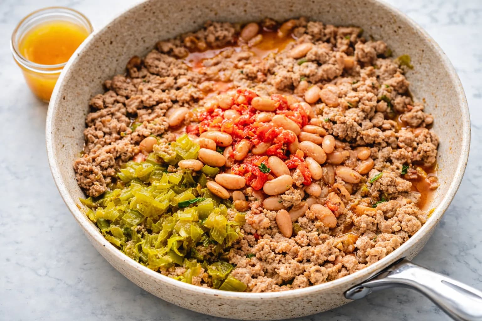 turkey sausage mixture with pinto beans and green chiles in skillet