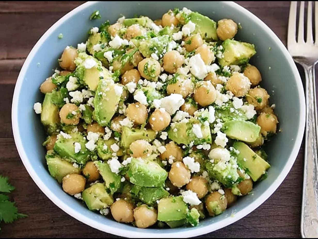 Bowl of Chickpea Feta Avocado Salad with cilantro and lime